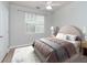 Bedroom with a brown bed, ceiling fan, and a patterned rug at 1429 Villa Capri Cir # 306, Odessa, FL 33556