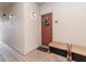 Building entry with a red door, wreath, and wooden benches at 1429 Villa Capri Cir # 306, Odessa, FL 33556