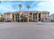 Building exterior with palm trees and ample parking at 1429 Villa Capri Cir # 306, Odessa, FL 33556