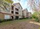 Tan multi-story building with balconies and landscaping at 1429 Villa Capri Cir # 306, Odessa, FL 33556