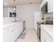 White kitchen with stainless steel appliances and tile floors at 1429 Villa Capri Cir # 306, Odessa, FL 33556