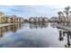 Serene lake with a fountain and reflecting community buildings at 1429 Villa Capri Cir # 306, Odessa, FL 33556