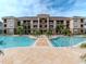 Inviting resort-style pool with plenty of lounge chairs and a spacious deck at 1429 Villa Capri Cir # 306, Odessa, FL 33556