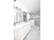 Elegant bathroom with double vanity, marble flooring, and a large walk-in shower at 158 Sun Isle Cir, Treasure Island, FL 33706