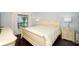 Elegant bedroom with cream-colored furniture and hardwood floors at 158 Sun Isle Cir, Treasure Island, FL 33706