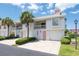 Two-story condo building with pink accents and lush landscaping at 158 Sun Isle Cir, Treasure Island, FL 33706