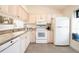 Well-equipped kitchen featuring granite countertops and white cabinetry at 158 Sun Isle Cir, Treasure Island, FL 33706