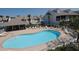 Community pool with plenty of lounge chairs and a covered patio area at 158 Sun Isle Cir, Treasure Island, FL 33706