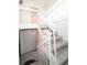 White staircase leading to condo entrance with pink door at 158 Sun Isle Cir, Treasure Island, FL 33706