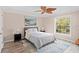 Comfortable bedroom with a queen-sized bed, stylish rug, and natural light from the window at 16346 Ashington Park Dr, Tampa, FL 33647