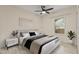 Bedroom with ceiling fan, large window, and wood-look floors at 16431 Enclave Village Dr # 208, Tampa, FL 33647