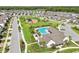 Aerial view of community with pool and playground at 16877 Red Brick Ln, Land O Lakes, FL 34638