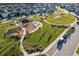 Aerial view of community playground and green space at 16877 Red Brick Ln, Land O Lakes, FL 34638