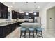 Modern kitchen with dark cabinetry and granite countertops at 17284 Old Tobacco Rd, Lutz, FL 33558