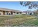 Landscaped backyard with grassy area and two homes at 1752 Atrium Dr, Sun City Center, FL 33573