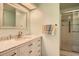 Bathroom features a large vanity with marble top and shower at 1752 Atrium Dr, Sun City Center, FL 33573