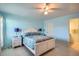 Bedroom with light blue walls, white bed frame, and ensuite bath at 1752 Atrium Dr, Sun City Center, FL 33573