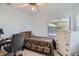 Small bedroom with a twin bed, desk, and dresser at 1752 Atrium Dr, Sun City Center, FL 33573