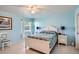 Light blue bedroom with white furniture and ceiling fan at 1752 Atrium Dr, Sun City Center, FL 33573