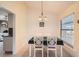 Dining area with white table and chairs, and view of kitchen at 1752 Atrium Dr, Sun City Center, FL 33573