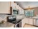 Bright kitchen features stainless steel appliances and granite countertops at 1752 Atrium Dr, Sun City Center, FL 33573