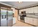 White kitchen cabinets, stainless steel appliances, and granite countertops at 1752 Atrium Dr, Sun City Center, FL 33573