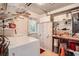 Laundry room with washer, dryer, and storage shelves at 1752 Atrium Dr, Sun City Center, FL 33573
