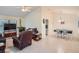 Living room with brown recliner, gray couch, and large TV at 1752 Atrium Dr, Sun City Center, FL 33573