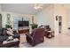 Living room with brown recliner, gray couch, and large TV at 1752 Atrium Dr, Sun City Center, FL 33573