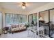 Bright sunroom, wicker furniture, and view of garden at 1752 Atrium Dr, Sun City Center, FL 33573