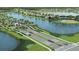 Aerial view of community, lake, and entrance at 18491 Green Garden Ct, Venice, FL 34293