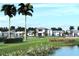 Community clubhouse with a water view and lush landscaping at 18491 Green Garden Ct, Venice, FL 34293