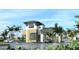Modern gated entrance to community with landscaping and palm trees at 18491 Green Garden Ct, Venice, FL 34293