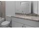 Bathroom with granite countertop, white cabinets, and a bathtub at 2009 Gardenia Ave, Port Charlotte, FL 33953