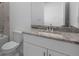 Clean bathroom with granite countertop, white cabinets, and a bathtub at 2009 Gardenia Ave, Port Charlotte, FL 33953