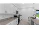 Modern kitchen with stainless steel appliances and granite island at 2009 Gardenia Ave, Port Charlotte, FL 33953
