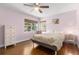 Serene bedroom with hardwood floors, natural light, and neutral tones, creating a relaxing retreat at 2025 Plaza Dolores, Clearwater, FL 33755