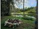 Stone fire pit nestled in a tranquil setting at 21732 Bell Lake Rd, Land O Lakes, FL 34639