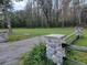 Landscaped front yard with wood and stone fence at 21732 Bell Lake Rd, Land O Lakes, FL 34639