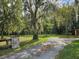 Landscaped yard with a stone driveway at 21732 Bell Lake Rd, Land O Lakes, FL 34639