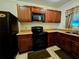 Galley kitchen with dark wood cabinets at 21732 Bell Lake Rd, Land O Lakes, FL 34639