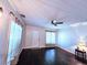 Bright living room with hardwood floors, ceiling fan, and window coverings at 21732 Bell Lake Rd, Land O Lakes, FL 34639