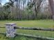 Vacant lot with grassy area and wooden fence at 21732 Bell Lake Rd, Land O Lakes, FL 34639