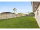Spacious backyard with grassy lawn and wooden fence at 2181 Wateroak N Dr, Clearwater, FL 33764