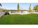 Large backyard with lush green grass and a patio area at 2181 Wateroak N Dr, Clearwater, FL 33764