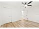 Simple bedroom with light wood floors and double closets at 2181 Wateroak N Dr, Clearwater, FL 33764