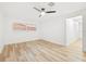 Simple bedroom with light wood floors and ceiling fan at 2181 Wateroak N Dr, Clearwater, FL 33764