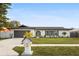 Newly renovated home with gray garage door and landscaped lawn at 2181 Wateroak N Dr, Clearwater, FL 33764