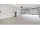 Attached garage with open door, concrete floor, and ample space at 2181 Wateroak N Dr, Clearwater, FL 33764