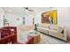 Spacious living area with light colored sofa and hardwood floors at 2181 Wateroak N Dr, Clearwater, FL 33764